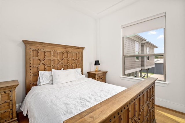 bedroom featuring baseboards and wood finished floors