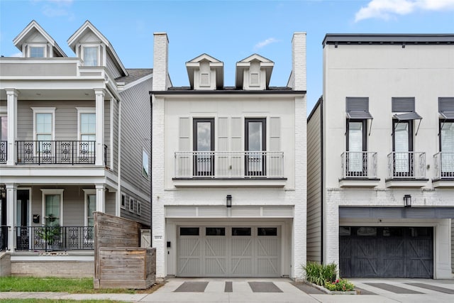 multi unit property featuring driveway and an attached garage