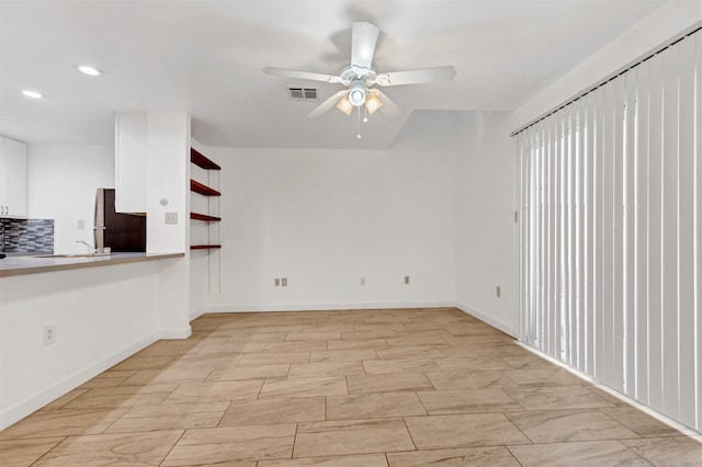 empty room featuring baseboards, recessed lighting, visible vents, and a ceiling fan