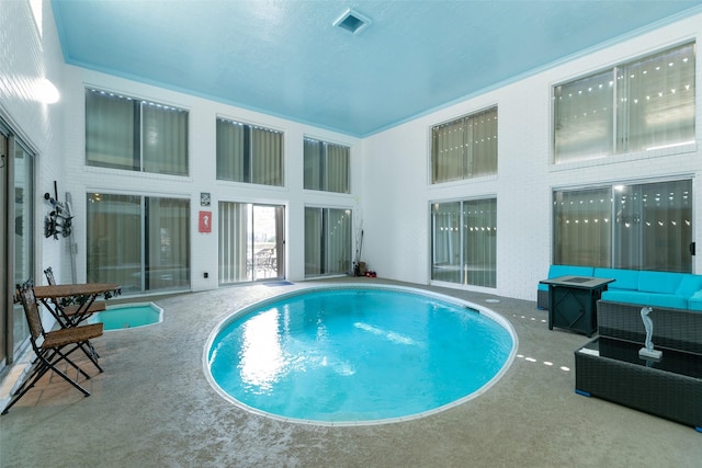 pool with a patio area and an outdoor hangout area