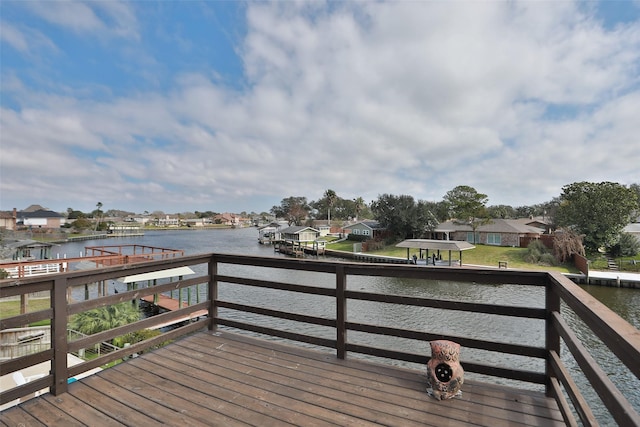 wooden terrace featuring a water view, a residential view, and a dock