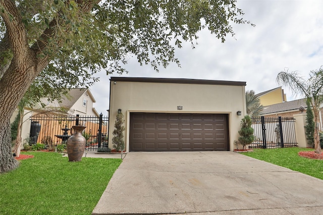 view of front of property with a front yard, fence, a gate, and stucco siding