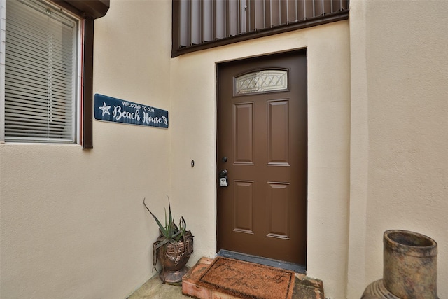 doorway to property with stucco siding