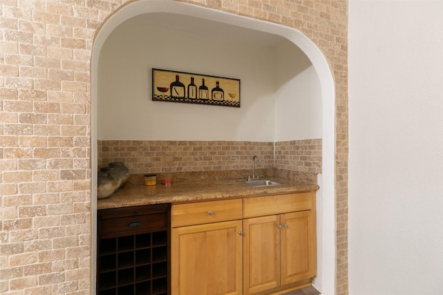 bar with wet bar and a sink