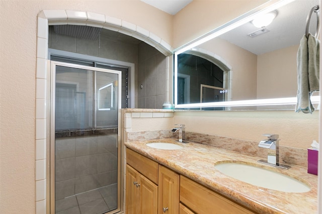 34 Lakeview Dr, Galveston, TX 77551 - bathroom with double vanity, a sink, a shower stall, and visible vents