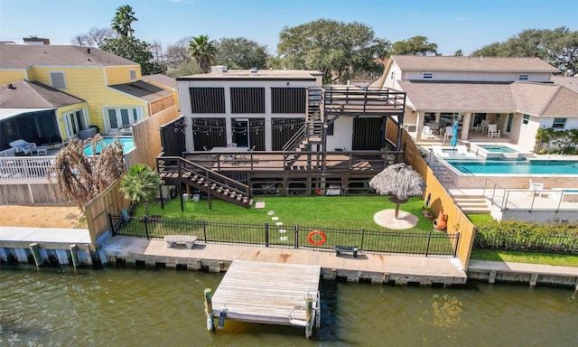 rear view of property featuring a patio, a fenced backyard, a deck with water view, a yard, and stairway