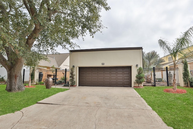 view of front of home featuring stucco siding, concrete driveway, a gate, fence, and a front lawn