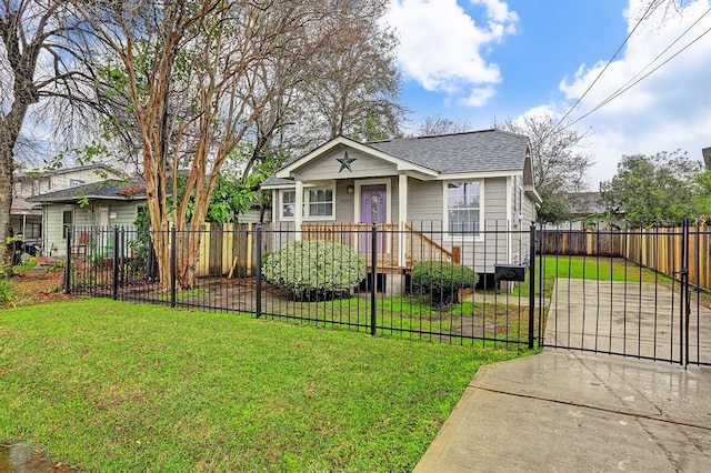 bungalow-style home featuring a fenced front yard, a gate, a front lawn, and roof with shingles