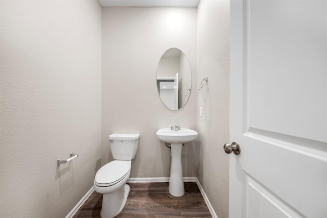 23923 Falling Daylight Dr, Hockley, TX 77447 - half bathroom with wood finished floors, toilet, and baseboards