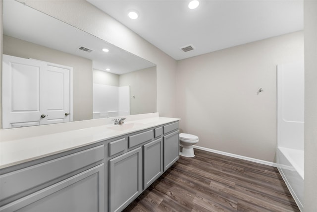 23923 Falling Daylight Dr, Hockley, TX 77447 - full bathroom with vanity, toilet, baseboards, wood finished floors, and recessed lighting
