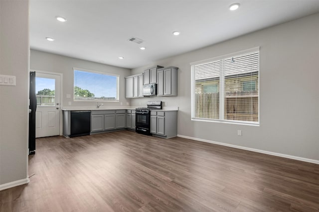 23923 Falling Daylight Dr, Hockley, TX 77447 - kitchen with black appliances, gray cabinetry, baseboards, and recessed lighting
