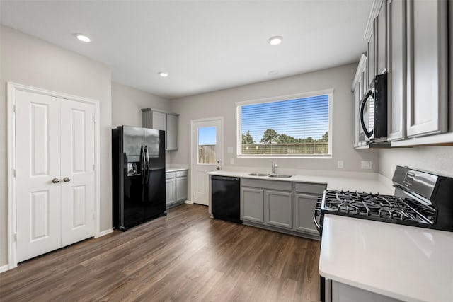 23923 Falling Daylight Dr, Hockley, TX 77447 - kitchen with black appliances, gray cabinetry, a sink, dark wood-style floors, and light countertops