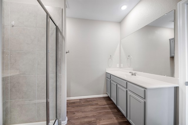 23923 Falling Daylight Dr, Hockley, TX 77447 - full bathroom featuring vanity, a stall shower, wood finished floors, and baseboards