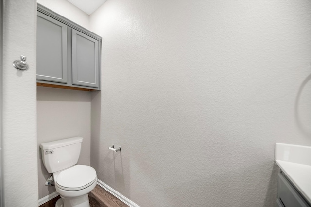 23923 Falling Daylight Dr, Hockley, TX 77447 - bathroom featuring vanity, wood finished floors, toilet, and baseboards