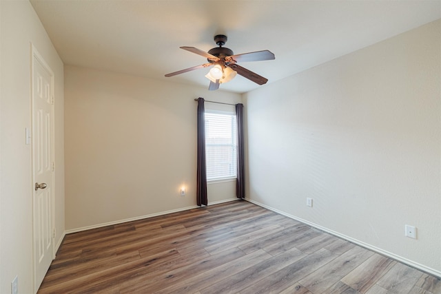 spare room with ceiling fan, baseboards, and wood finished floors