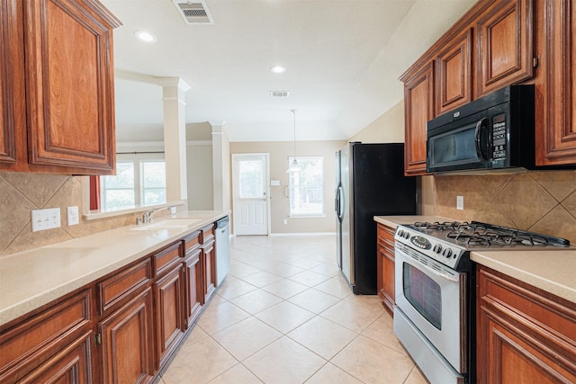 kitchen with ornate columns, visible vents, appliances with stainless steel finishes, and a sink