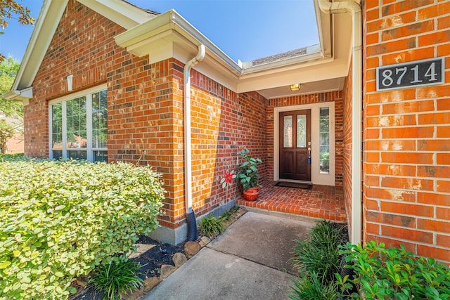 doorway to property with brick siding