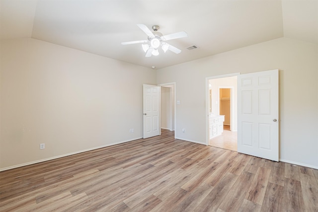 unfurnished bedroom featuring light wood-style floors, visible vents, vaulted ceiling, and ceiling fan