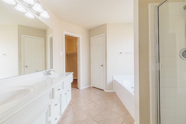 full bath with a garden tub, a sink, a shower stall, and tile patterned floors