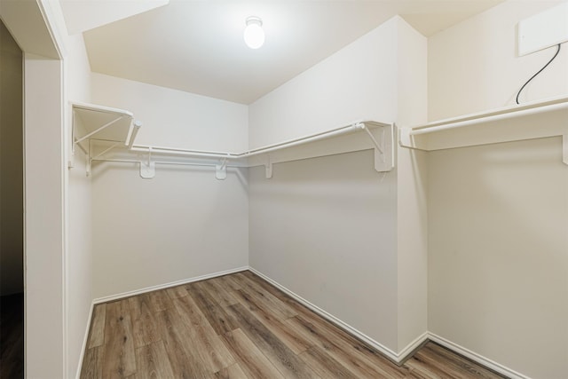 spacious closet with wood finished floors