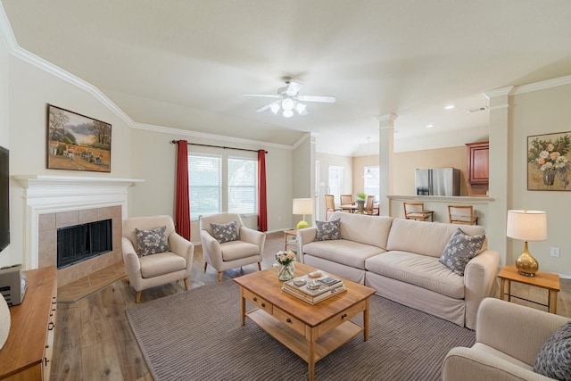 8714 Ridgebury Cir, Houston, TX 77095 - living room with ornate columns, ornamental molding, light wood finished floors, and ceiling fan