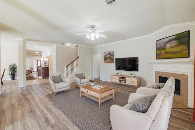 8714 Ridgebury Cir, Houston, TX 77095 - living room featuring visible vents, light wood-style flooring, ceiling fan, and a tile fireplace