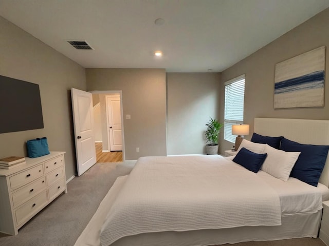 bedroom featuring recessed lighting, visible vents, and light colored carpet