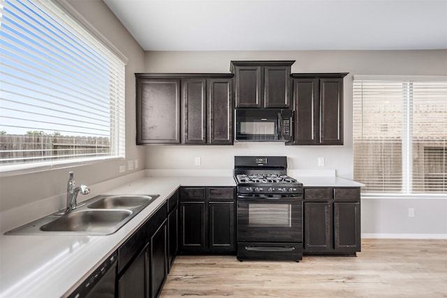 23947 Falling Daylight Dr, Hockley, TX 77447 - kitchen featuring black appliances, a sink, light wood finished floors, and light countertops