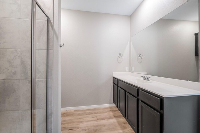 23947 Falling Daylight Dr, Hockley, TX 77447 - bathroom featuring wood finished floors, a shower stall, vanity, and baseboards