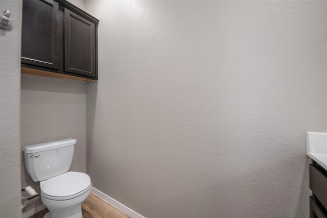 23947 Falling Daylight Dr, Hockley, TX 77447 - bathroom with wood finished floors, toilet, baseboards, and vanity
