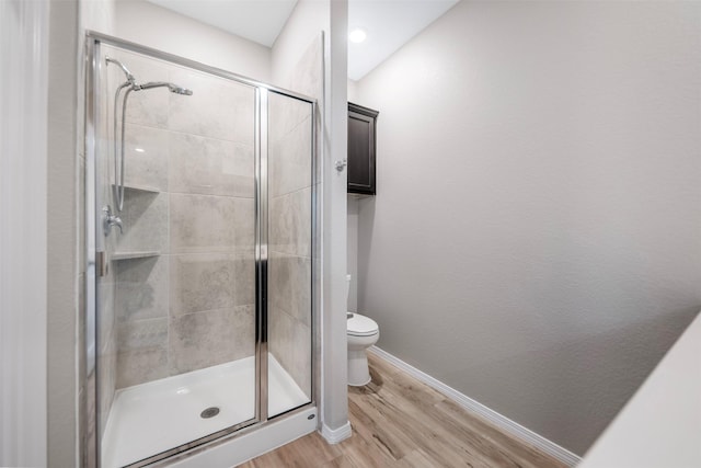 23947 Falling Daylight Dr, Hockley, TX 77447 - full bathroom featuring a shower stall, wood finished floors, baseboards, and toilet