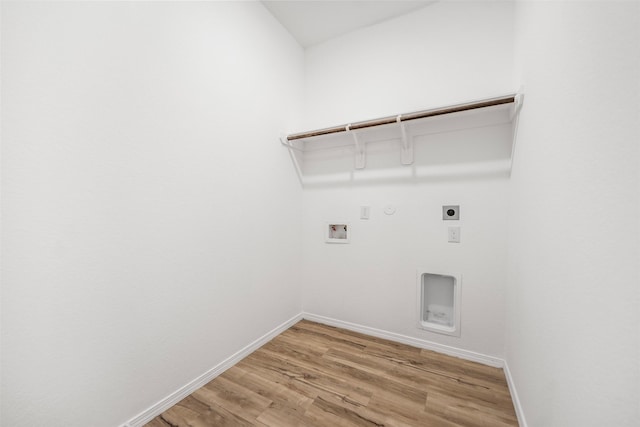 23947 Falling Daylight Dr, Hockley, TX 77447 - clothes washing area featuring electric dryer hookup, hookup for a gas dryer, hookup for a washing machine, light wood-style flooring, and baseboards