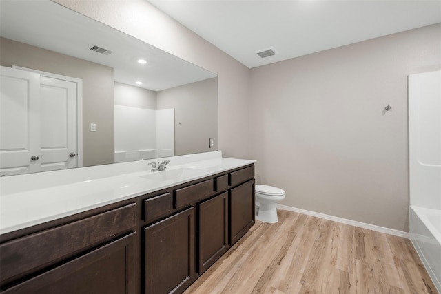 23947 Falling Daylight Dr, Hockley, TX 77447 - full bathroom with wood finished floors, toilet, vanity, and baseboards