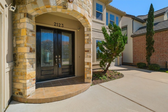 entrance to property with stone siding and french doors