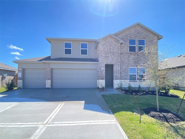 traditional-style home featuring concrete driveway, stone siding, an attached garage, a front lawn, and brick siding