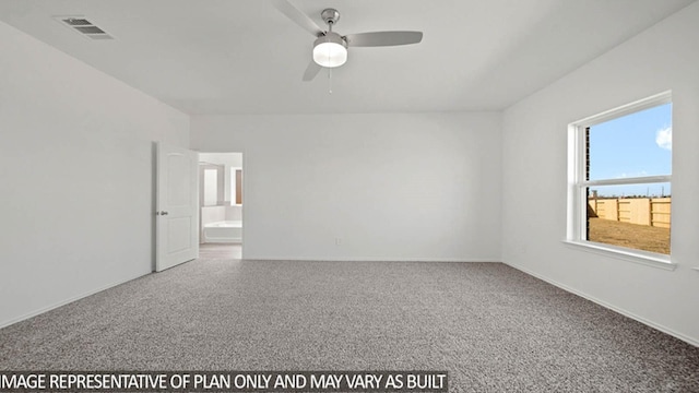 spare room featuring carpet, visible vents, ceiling fan, and baseboards