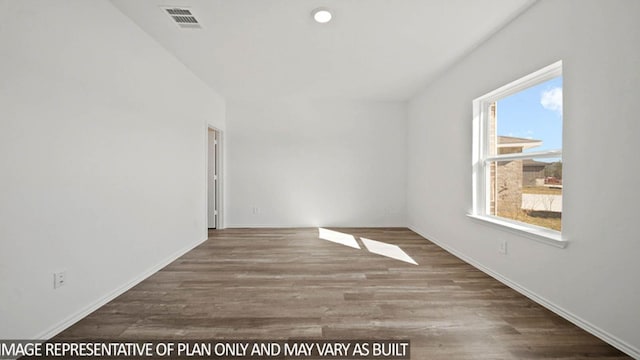 empty room with recessed lighting, wood finished floors, visible vents, and baseboards