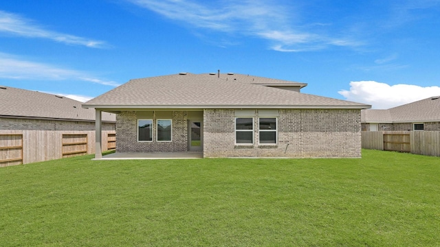729 Nueces Ln, Dayton, TX 77535 - rear view of house with brick siding, a patio area, and a shingled roof