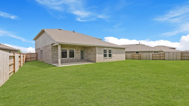 729 Nueces Ln, Dayton, TX 77535 - back of property with brick siding, a patio, and roof with shingles