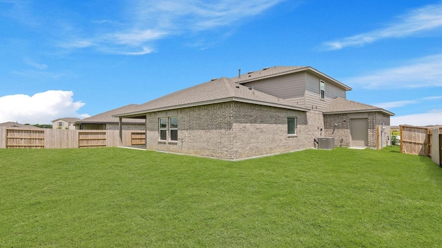 729 Nueces Ln, Dayton, TX 77535 - rear view of property with brick siding, a shingled roof, and central AC