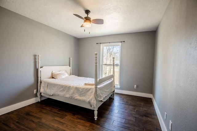 bedroom featuring baseboards, dark wood-style floors, and ceiling fan