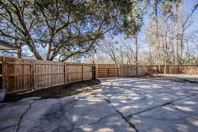 view of yard with fence and a gate