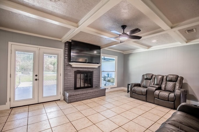 living room featuring french doors, light tile patterned flooring, beam ceiling, coffered ceiling, and a ceiling fan
