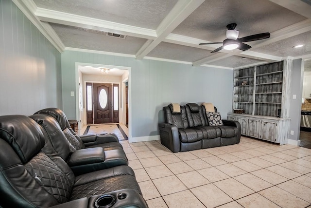 living room with ornamental molding, light tile patterned flooring, a ceiling fan, beam ceiling, and a textured ceiling
