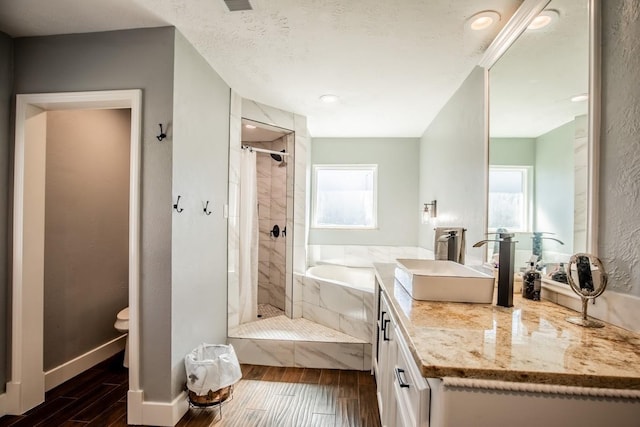 full bath featuring tiled shower, wood finished floors, vanity, and baseboards