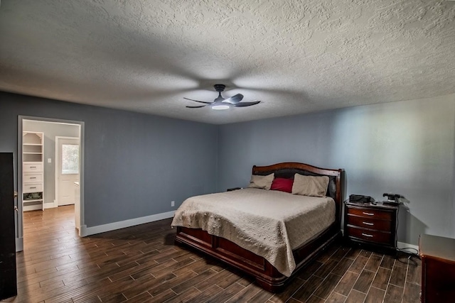 bedroom with wood finished floors, baseboards, a textured ceiling, and a ceiling fan