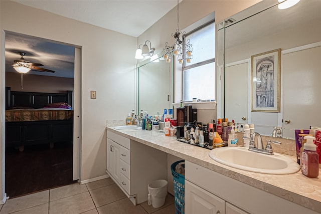 full bath with double vanity, ensuite bath, tile patterned flooring, and a sink