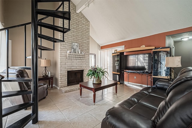 tiled living area with baseboards, beamed ceiling, a fireplace, high vaulted ceiling, and track lighting