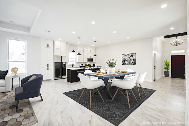 dining area with recessed lighting and a notable chandelier