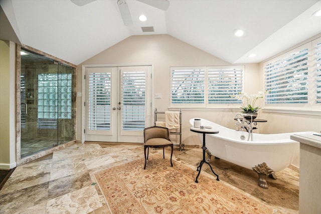 bathroom with a stall shower, visible vents, vaulted ceiling, a healthy amount of sunlight, and a freestanding tub